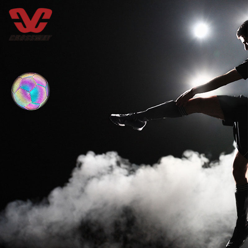 Person kicking a soccer ball with a dark background and a visible logo at the top left corner.