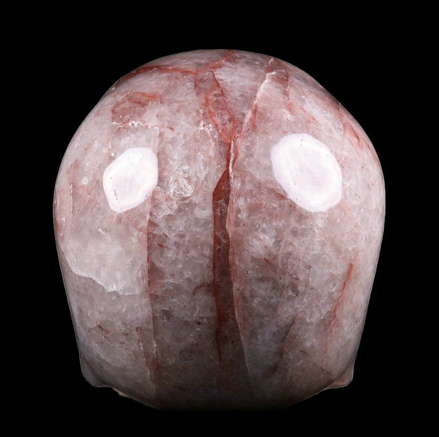 Decorative stone with a face-like design on a white background