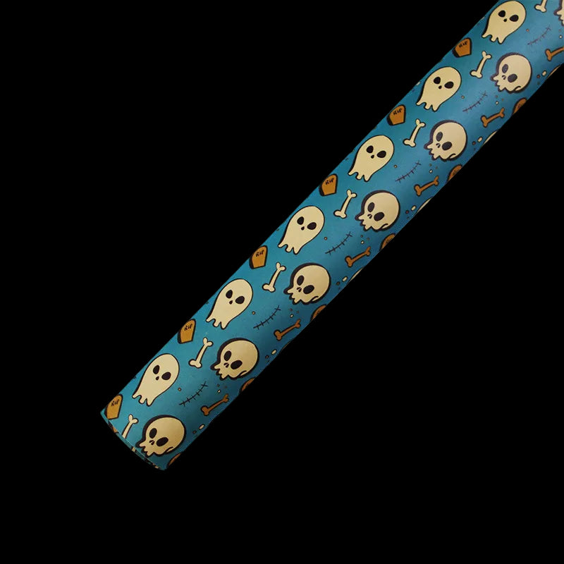 Fabric strip with skull and bone pattern on a blue background