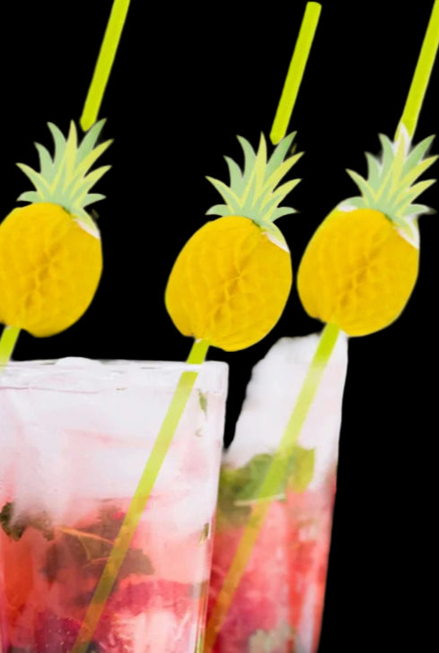 Two glasses of pink drinks with pineapple-shaped straws on a white background