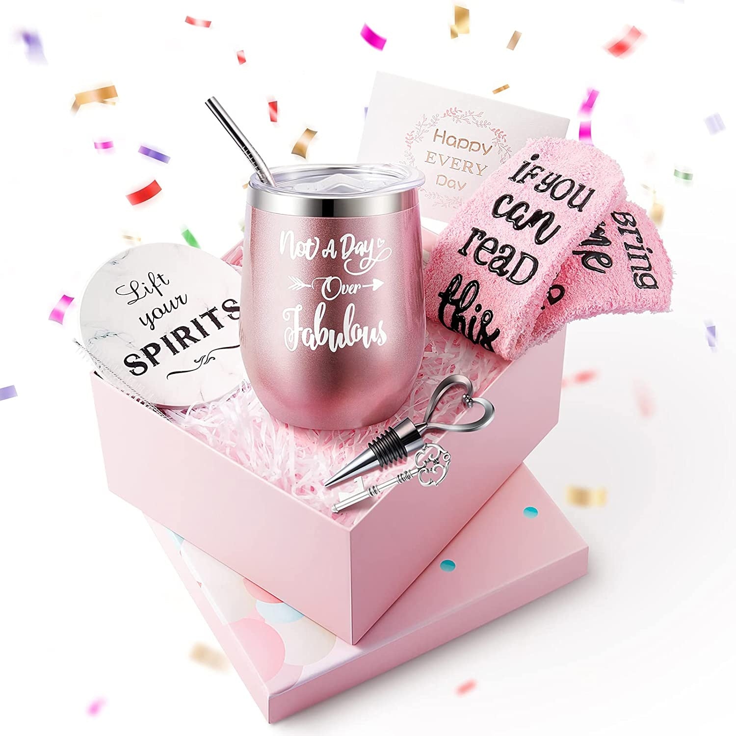 Pink wine tumbler with accessories in a gift box with confetti around