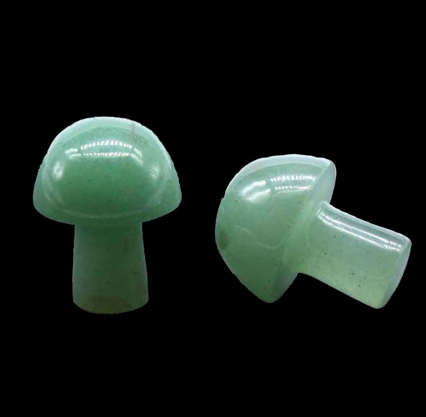 Two green plastic mushroom-shaped objects on a white background