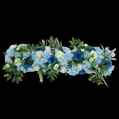 Floral arrangement with blue and white flowers on a white background