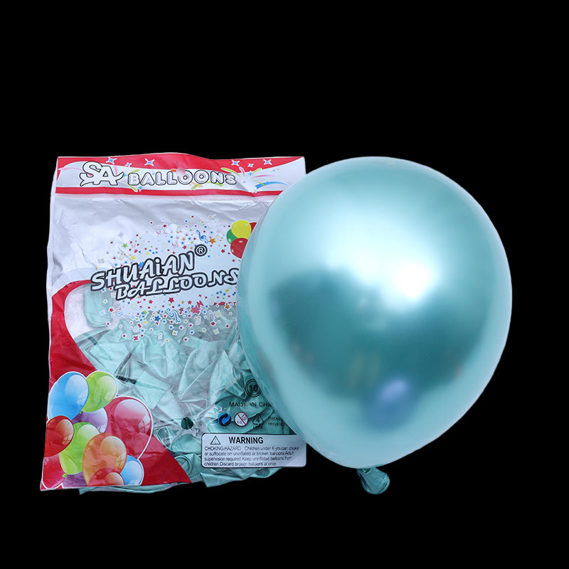 Turquoise balloon next to its packaging on a white background
