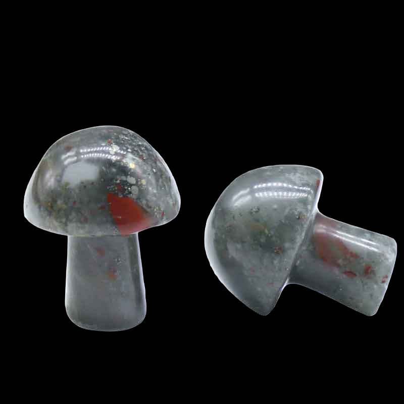Two gray stone mushrooms with red spots on a white background