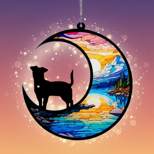 Decorative hanging with a silhouette of a dog on a crescent moon, set against a colorful landscape.