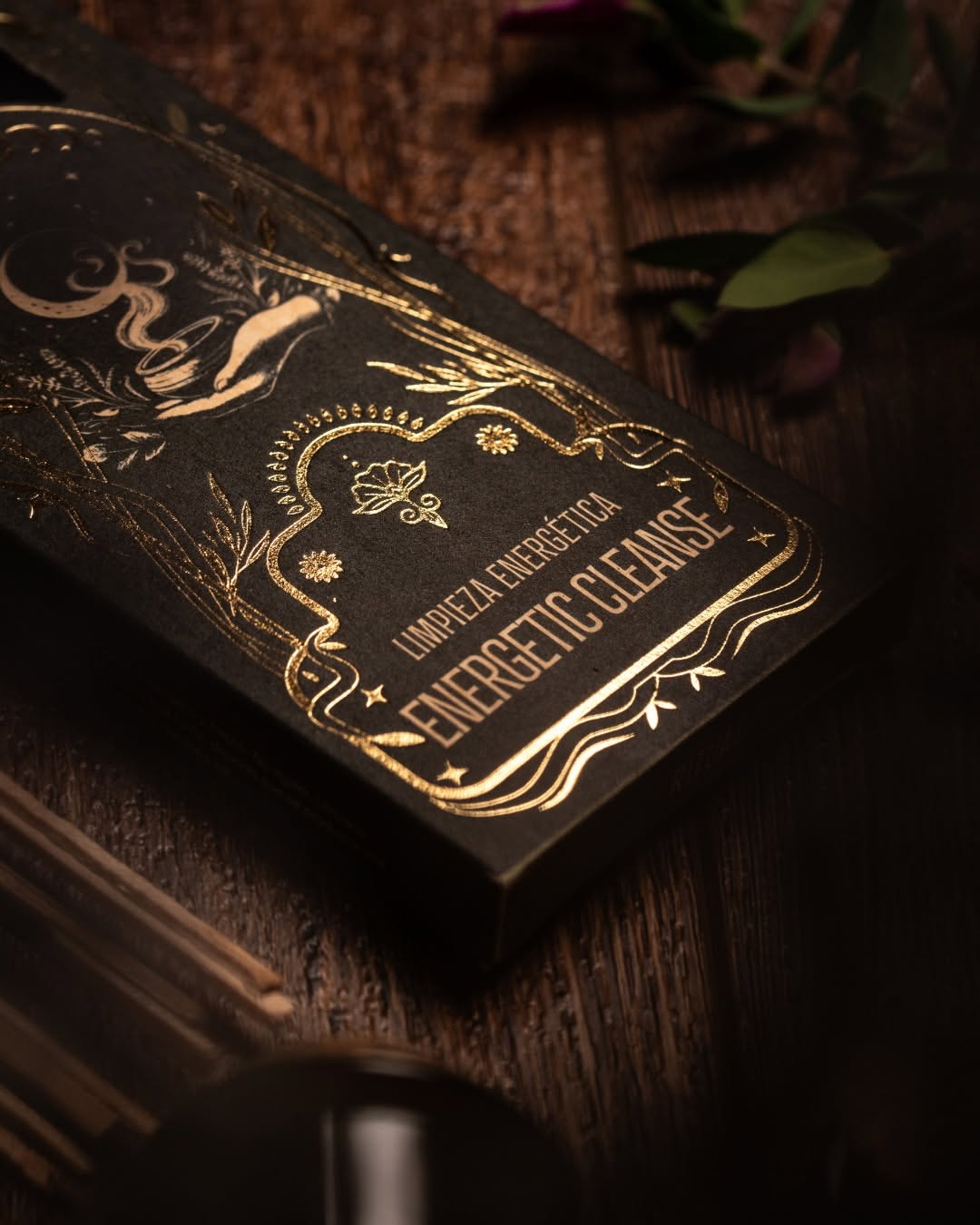Decorative black box with gold text on a wooden surface