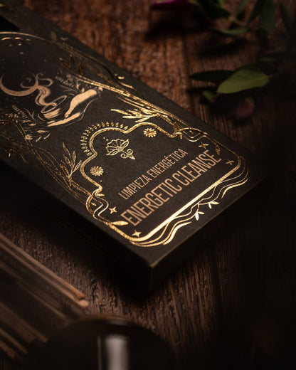 Decorative black box with gold text on a wooden surface