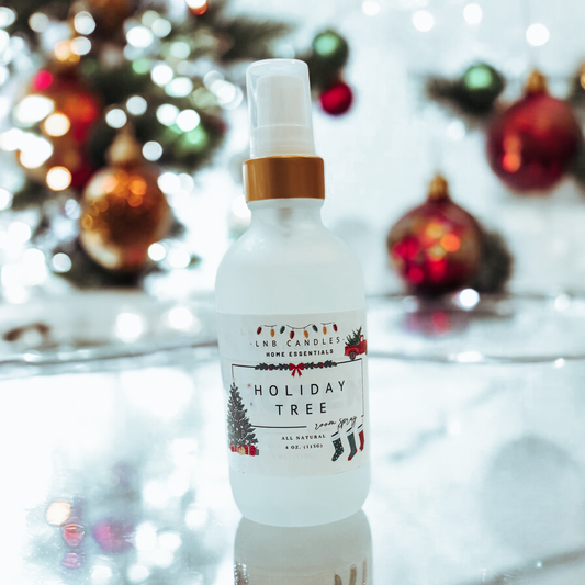 Bottle of 'Holiday Tree' product with Christmas decorations in the background