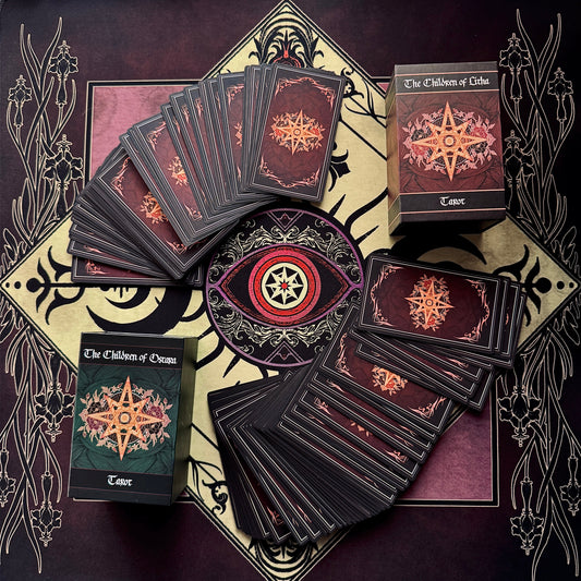 A set of tarot cards from 'The Children of Osiris' deck arranged in a flat-lay on a matching decorative tarot mat. The cards are fanned out and stacked, showing dark maroon backs with gold star illustrations, alongside two boxed decks, one with a green cover and one with a dark red cover.