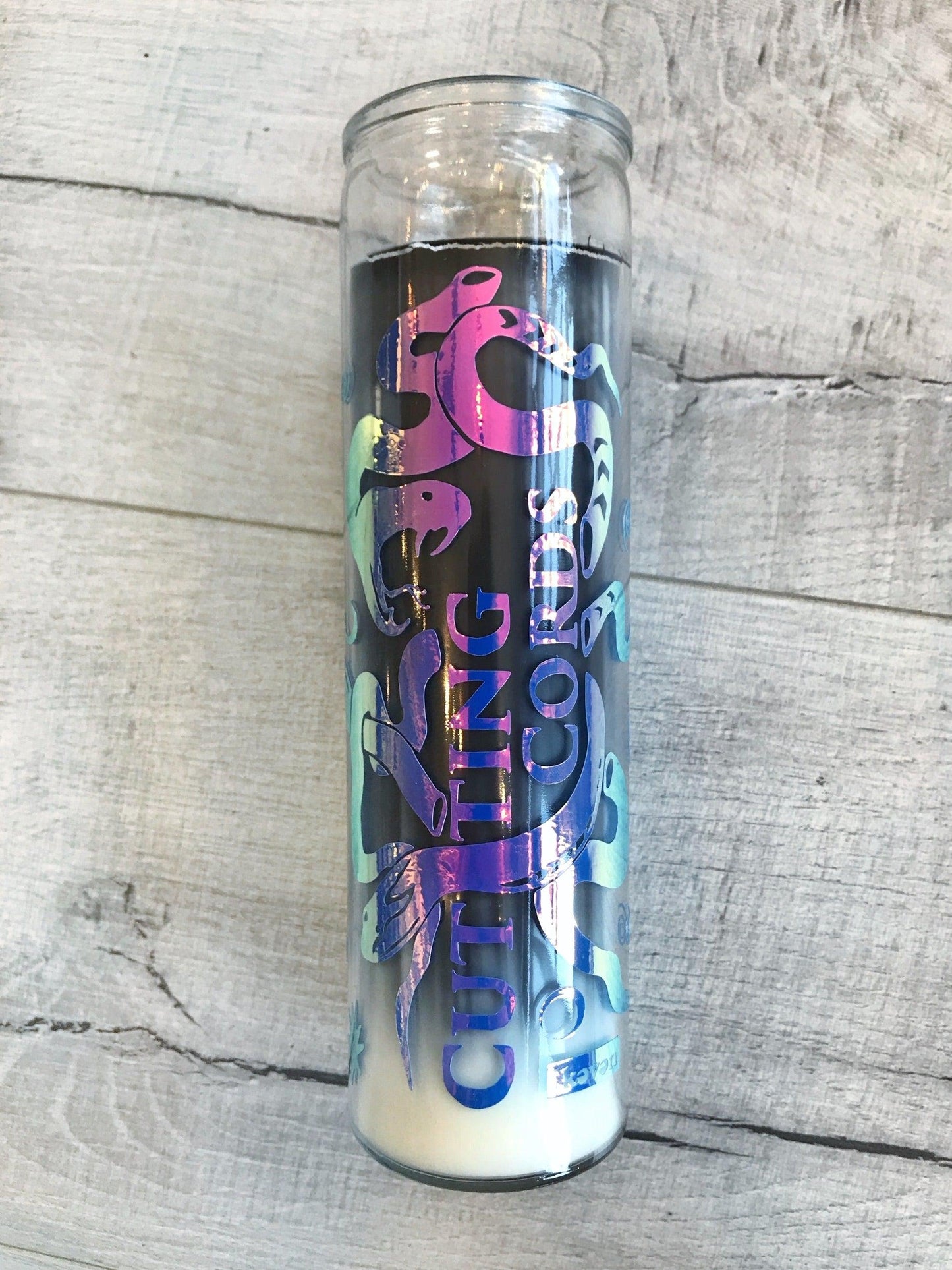 Tumbler with colorful design on a wooden surface