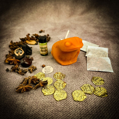 Spices, gold coins, and a bottle on a textured surface