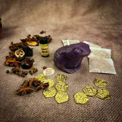 Spices, a bottle, and gold coins on a textured surface