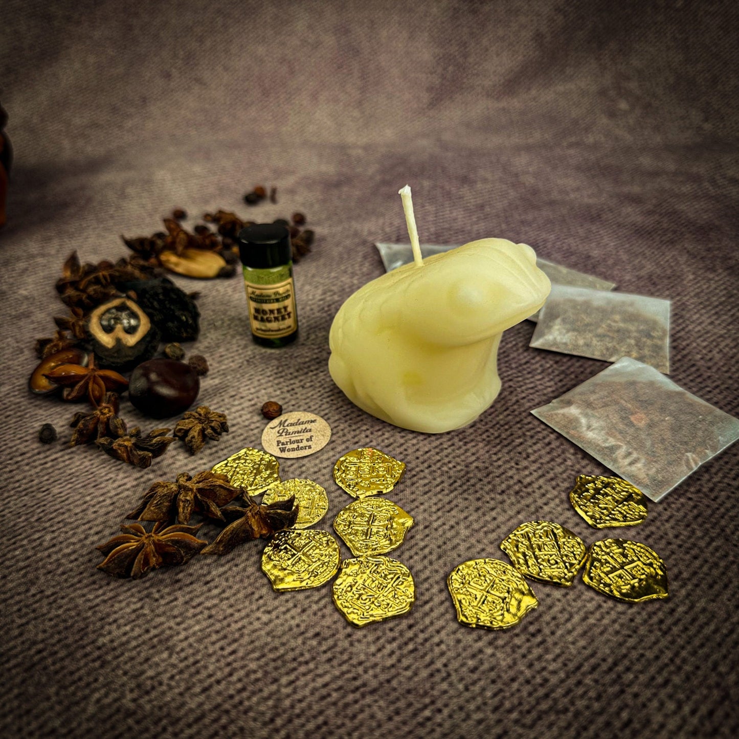 Candle, bottle, and gold leaf on a textured surface