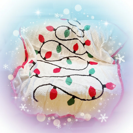 Decorative towel with Christmas lights design on a couch.