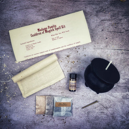 Magical spell kit with a black candle, scroll, and other items on a textured surface.