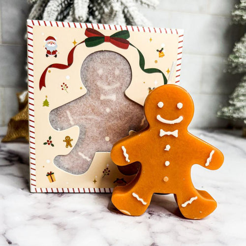 Gingerbread man decoration with a cardboard standee on a decorative box.