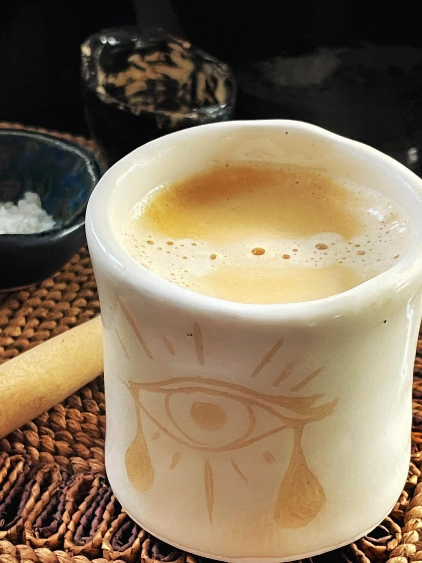 Ceramic mug with a design on a woven surface