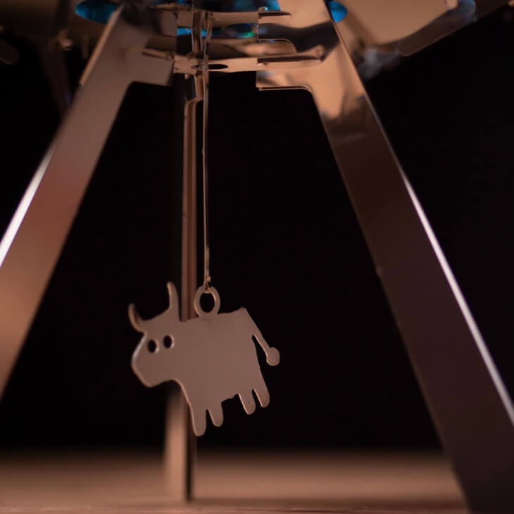 3D-printed bison pendant emerging from a 3D printer
