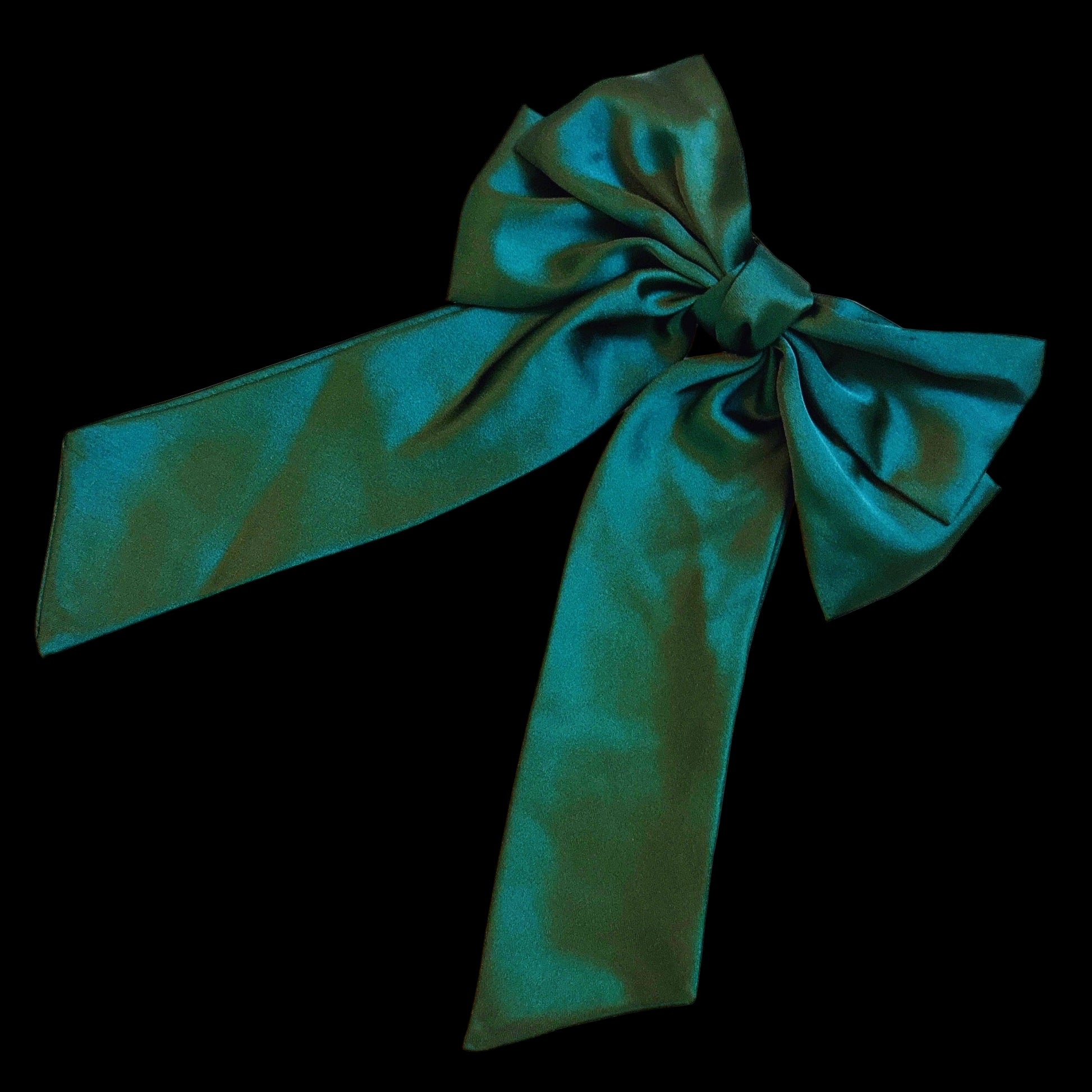 Green satin bow on a light gray background