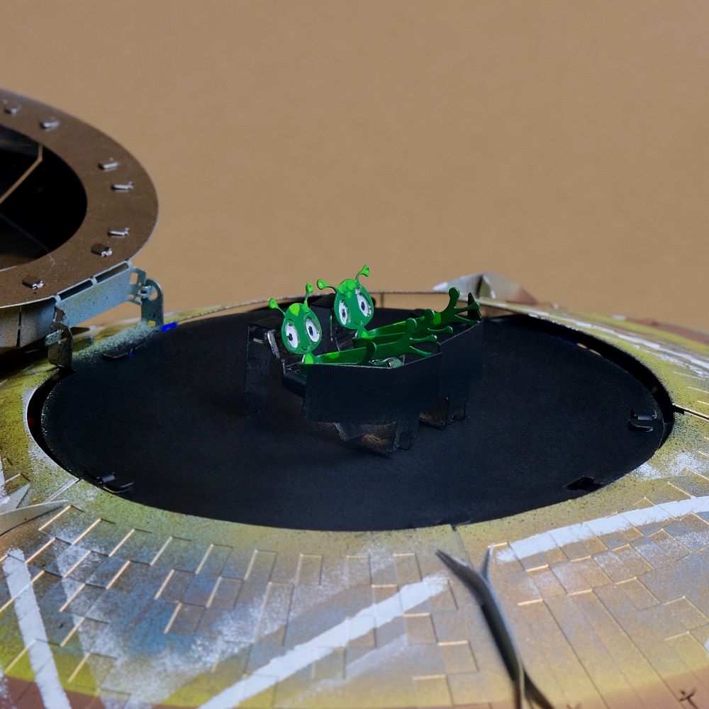 Toy robot on a round platform with a brown background