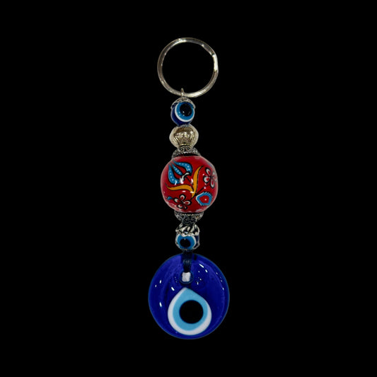 Keychain with colorful bead and blue evil eye charm on a white background