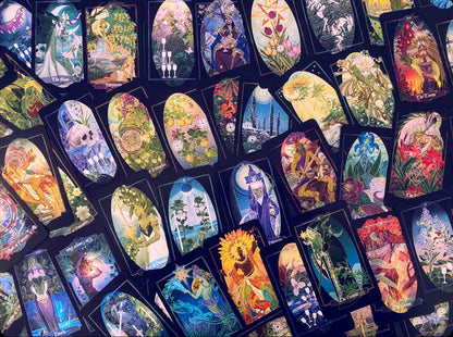 A dense arrangement of illustrated tarot or oracle cards with colorful fantasy and floral artwork, overlapping each other on a dark background.