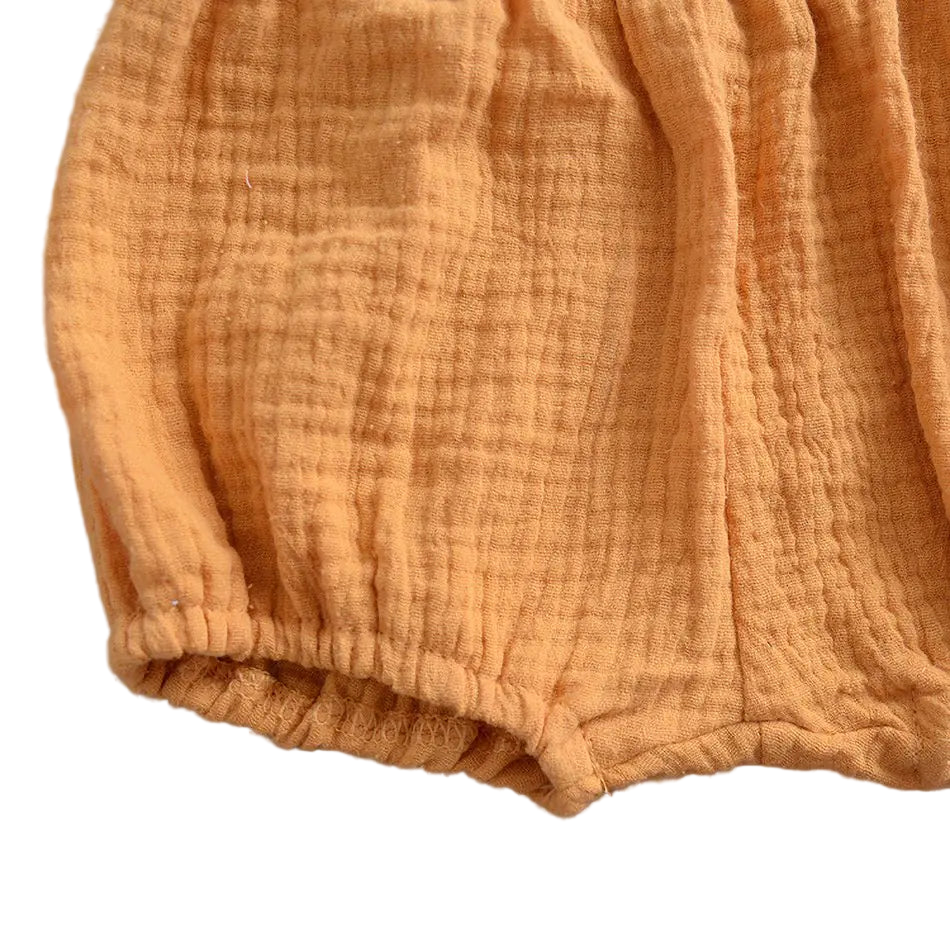 Folded orange fabric on a gray background