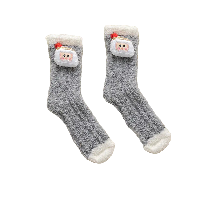 Pair of gray socks with Santa face design on a white fluffy surface