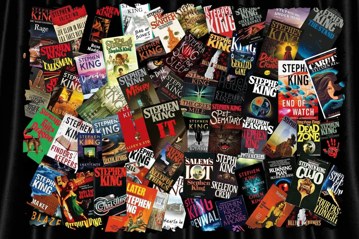 A dense collage of many Stephen King book covers arranged in a flat lay, with the author's name and various titles visible across the overlapping covers.