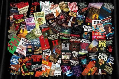 A dense collage of many Stephen King book covers arranged in a flat lay, with the author's name and various titles visible across the overlapping covers.