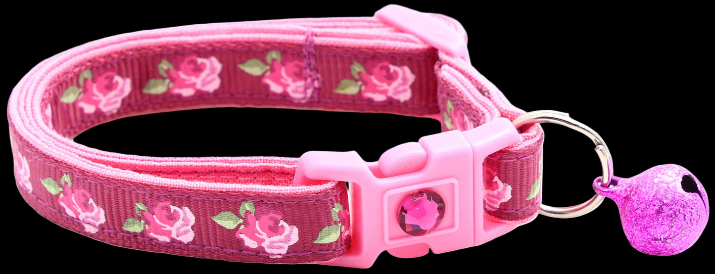 Pink floral dog collar with a bell on a white background