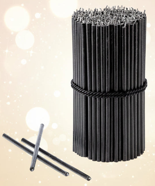 Roll of black bristle brush with two additional brushes on a white background