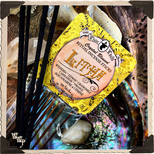 Yellow package of ritual incense sticks with decorative elements on a textured background