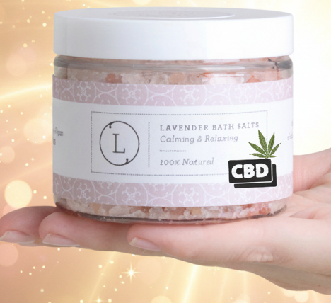 Hand holding a jar labeled 'CBD' with a visible brand logo on a white background