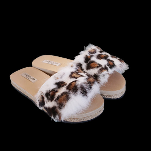 Pair of leopard print slippers on a light blue surface