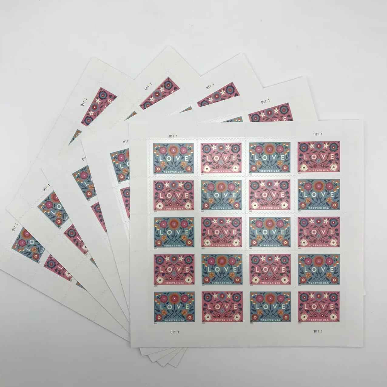 Sheets of stamps with floral designs and 'LOVE' text on a white background