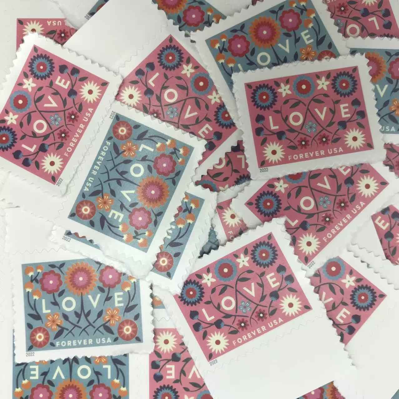 Collection of floral 'LOVE' stamps with decorative designs on a white background.