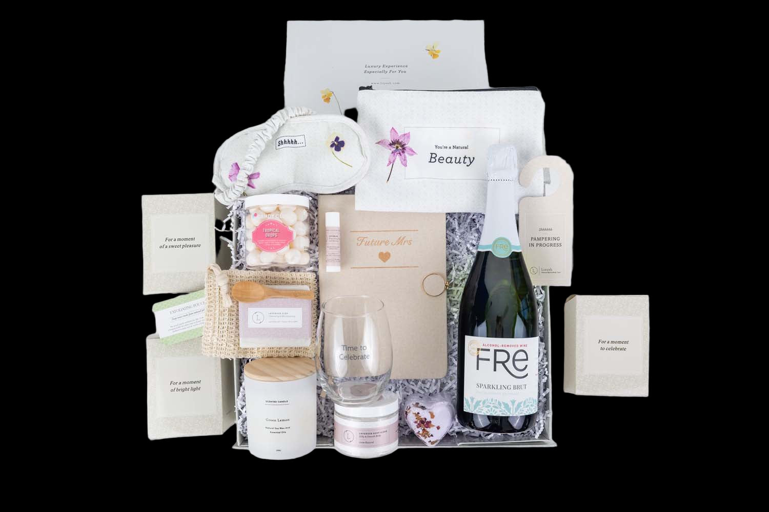 Gifting set with candles, bottles, and decorative items on a white background