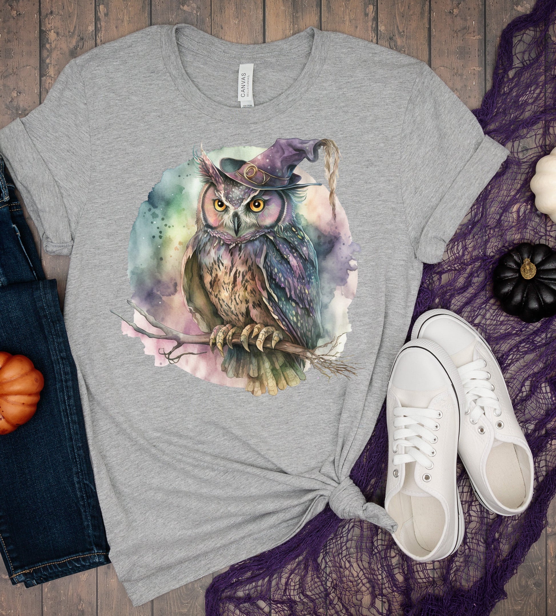 Gray t-shirt with owl design, jeans, sneakers, and pumpkins on a wooden surface