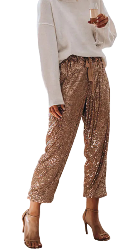 Person wearing gold sequin pants in a living room setting with a Christmas tree.