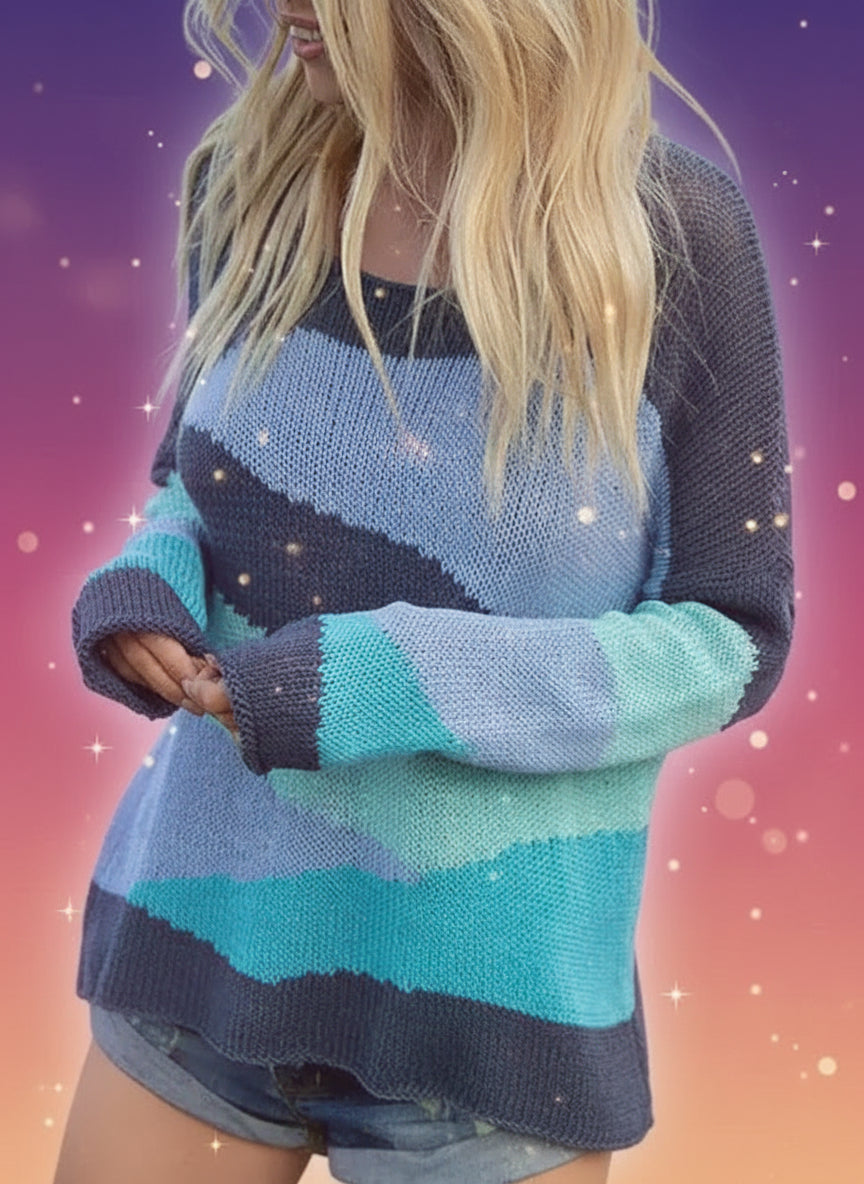 Person wearing a colorful striped sweater on a beach