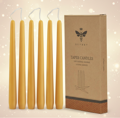 Set of six yellow taper candles with a cardboard box labeled 'DEBBY' on a white background.