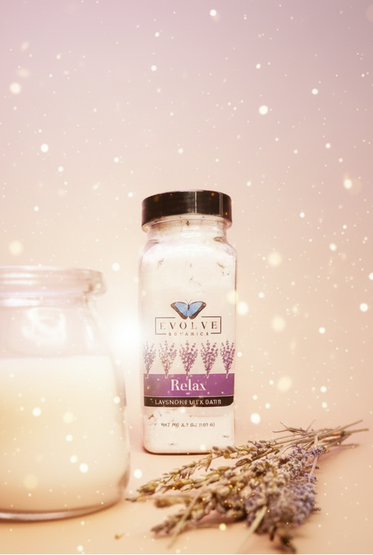 Bottle of Evolve Botanica lavender milk bath next to a jar of milk on a purple background