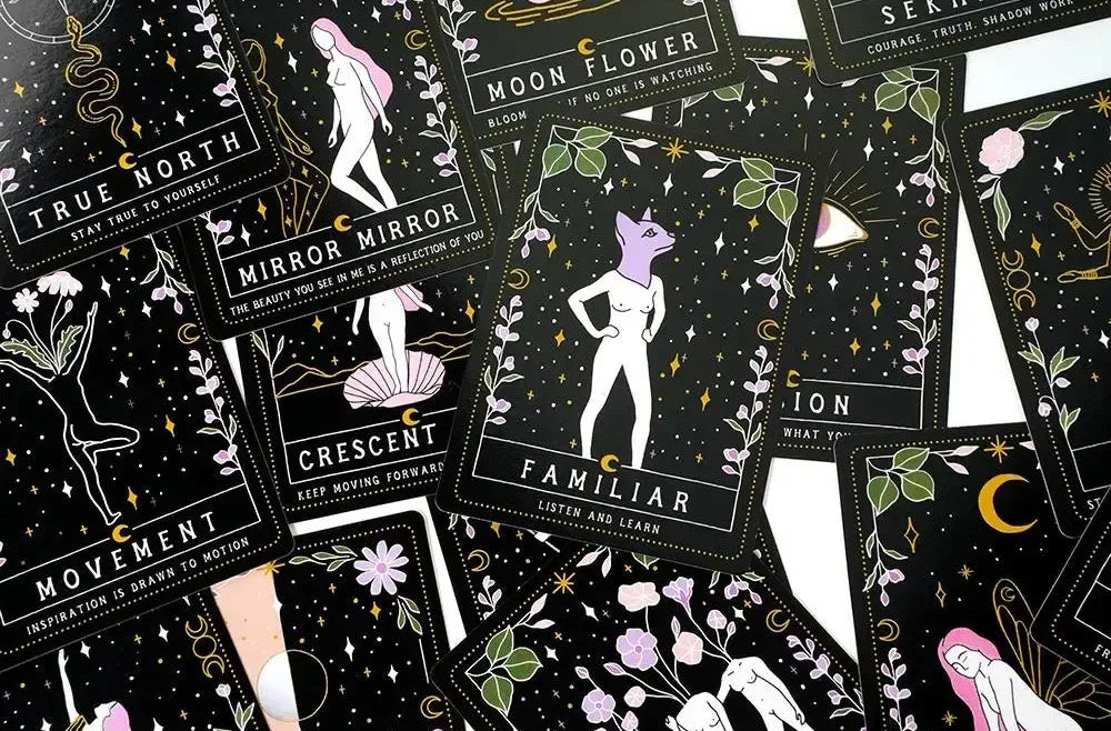 Collection of tarot cards with black backgrounds and white and colorful illustrations.