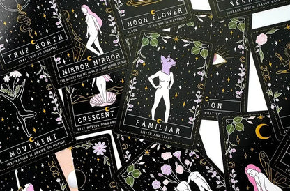 Collection of tarot cards with black backgrounds and white and colorful illustrations.