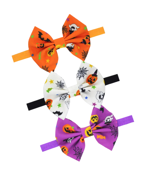 Set of three Halloween-themed hair bows on white background