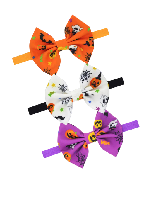 Set of three Halloween-themed hair bows on white background