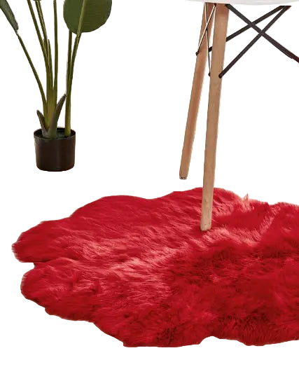 Red fluffy rug on a wooden floor with a chair and plant in the background
