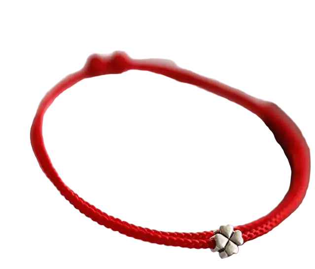 Red bracelet with a silver charm on a light background